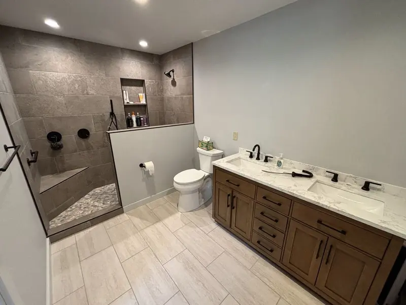 Bigger bathroom with a walk-in shower by Tri-County Professional Builders