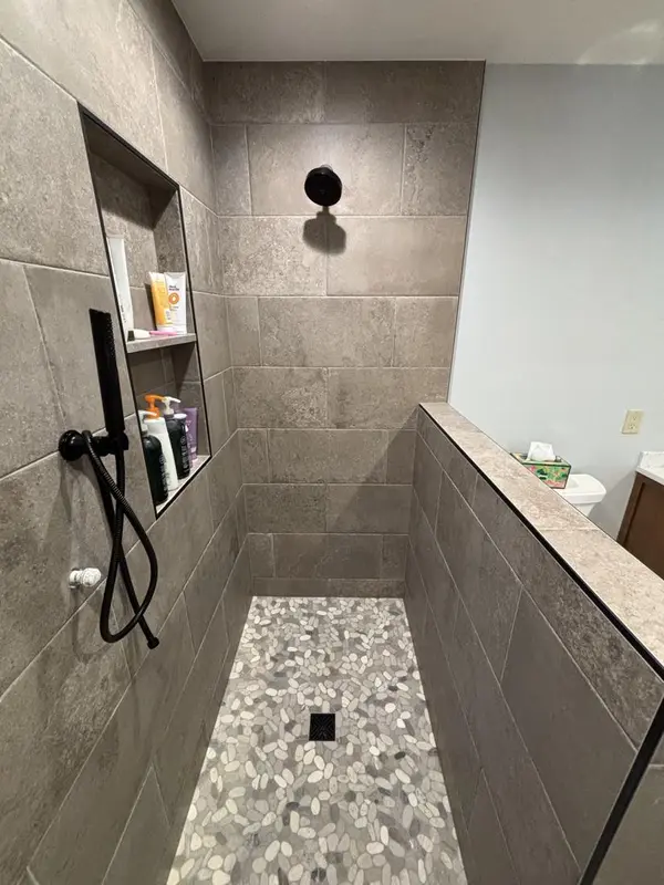 Bigger bathroom with a walk-in shower by Tri-County Professional Builders