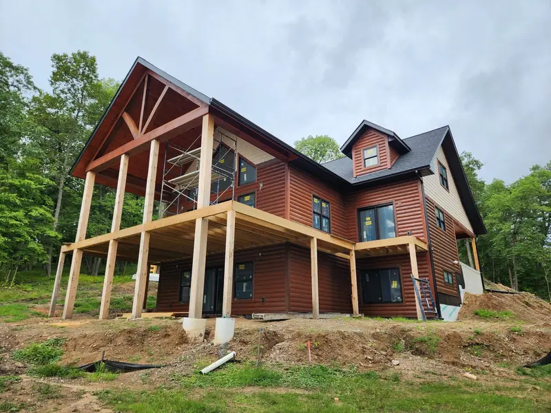Log siding on a new home by Tri-County Professional Builders