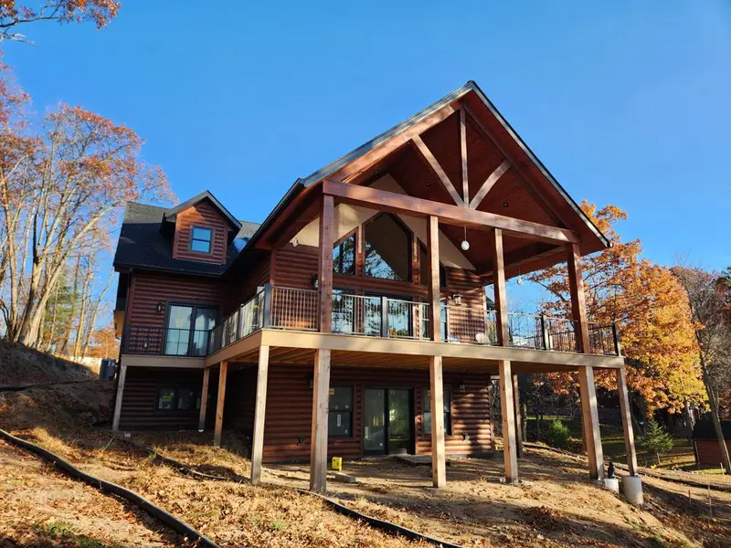Lake home exterior with new siding, roofing and windows