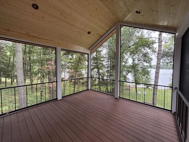 Screen porch addition with pine ceiling and lake view